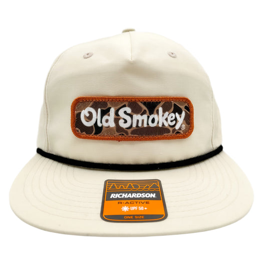 Front view of a beige hat with Old Smokey brown camo logo