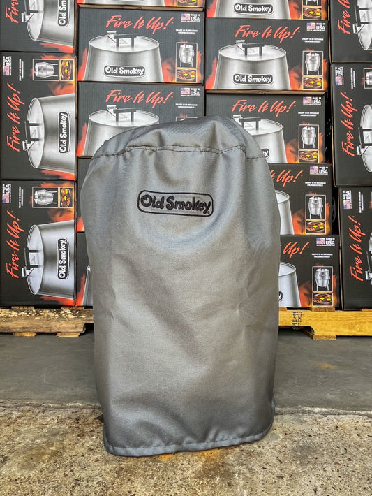 Grey grill cover over an Old Smokey Charcoal Grill