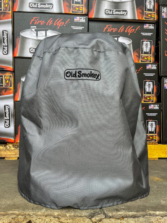 Grey grill cover with 'Old Smokey' branding on a store floor.